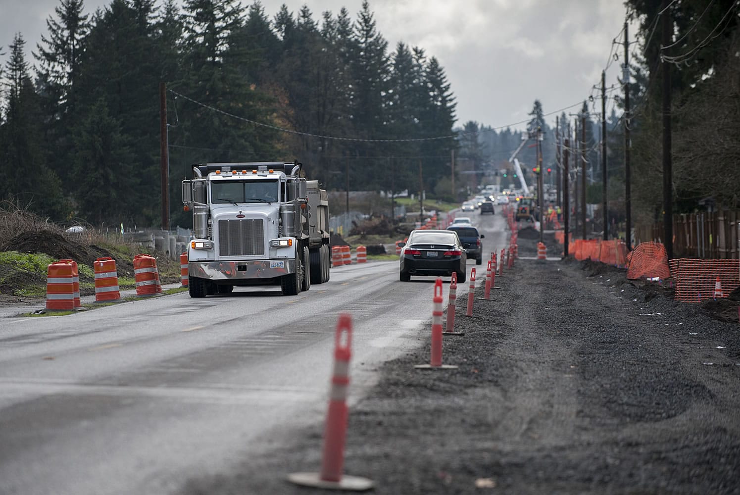 Motorists navigate past construction barriers the afternoon of Nov. 24 along Northeast 94th Avenue in Vancouver. Construction is ongoing to widen and improve the road, and is slated to be finished next fall.
