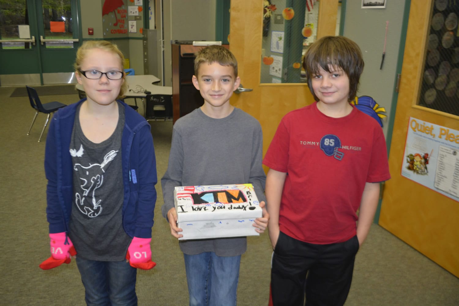 Washougal: Cape Horn-Skye Elementary School fourth-graders Briana Kistner, from left, Aiden Imel and Chase Delp help prepare treats and words of encouragement to be sent to military members serving overseas.