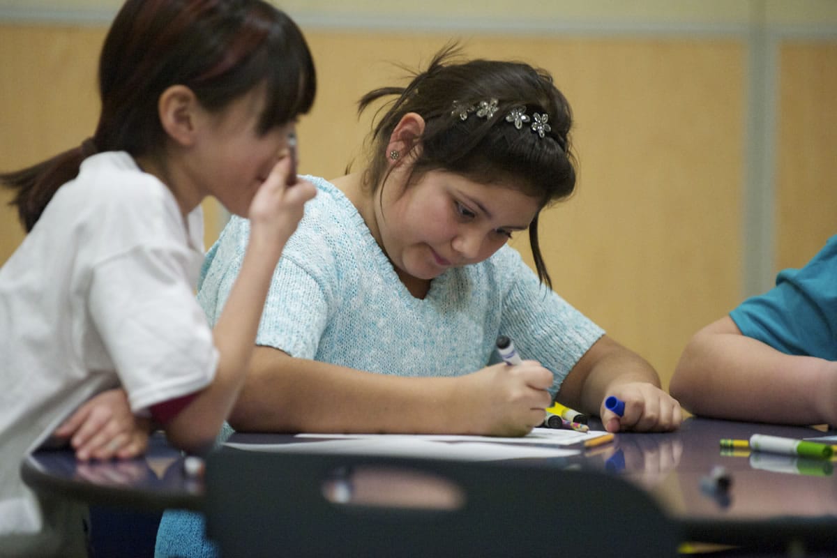 Onika Estrada, 10, left, draws  with friends at the Boys and Girls Club at Washington Elementary School on Jan. 14.