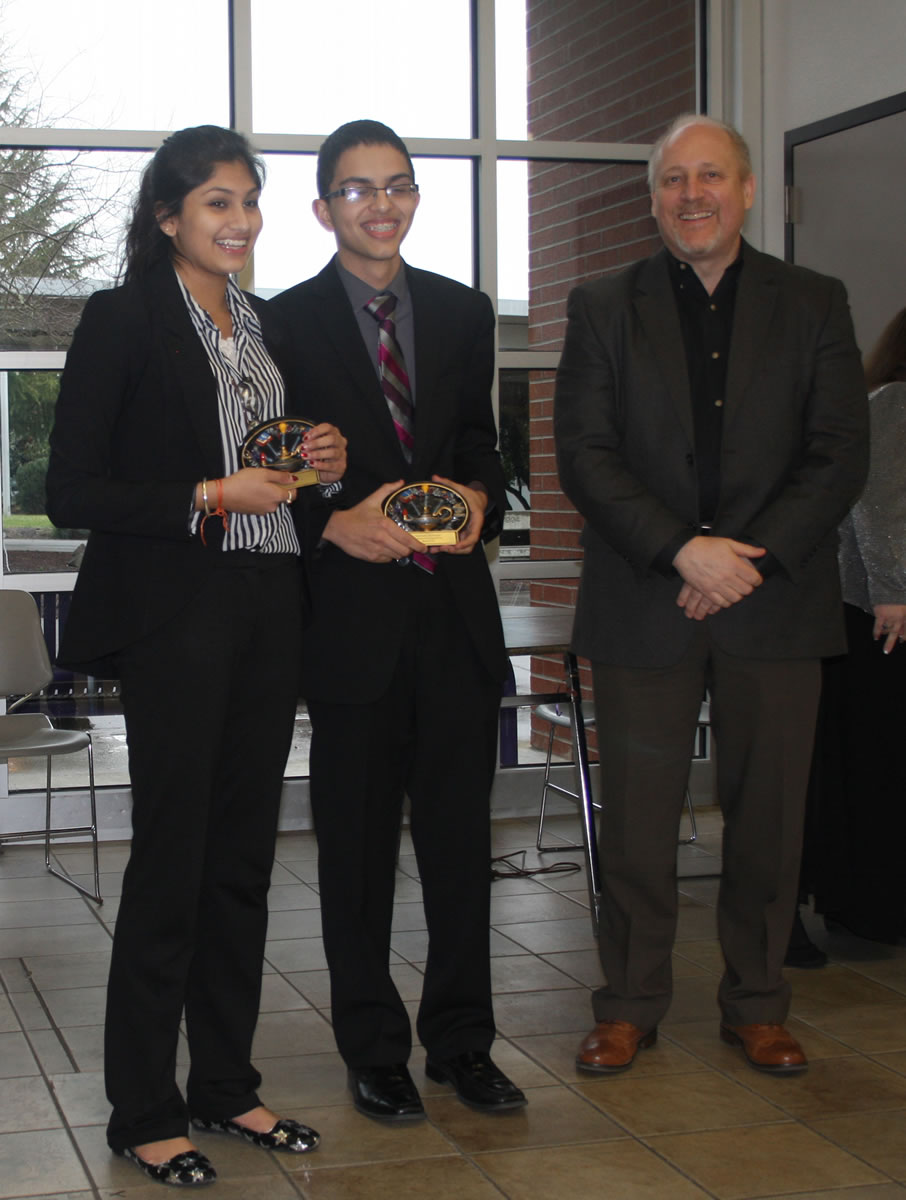 Felida: Camas High Schoolers Meghal Sheth, left, and Reesab Pathak are awarded Best of Fair honors by Bonneville Power Administration's Larry Bekkedahl on March 1 at the Southwest Washington Science and Engineering Fair, held at Columbia River High School.