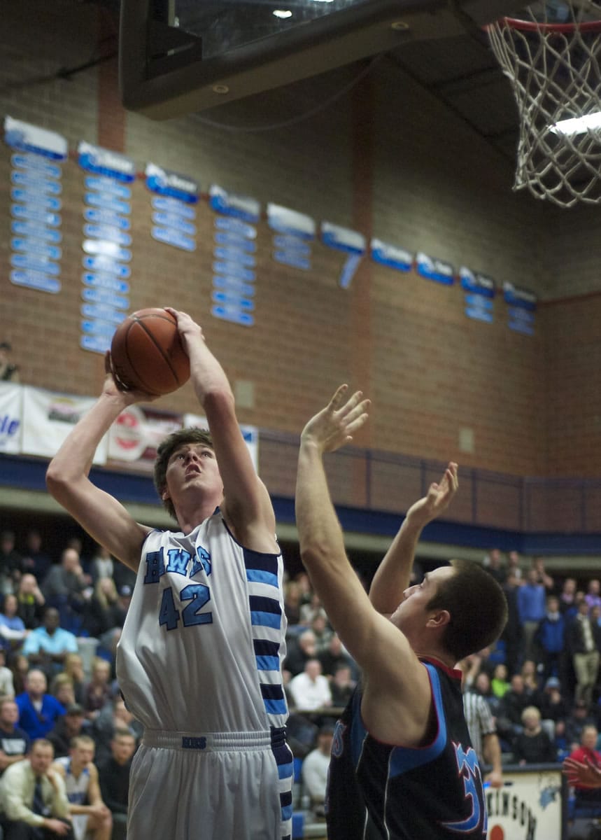 Hockinson's Littleton Davidson puts up a shot against Mark Morris' Jared Bartleson during the second half at HHS on Thursday January 9, 2014.