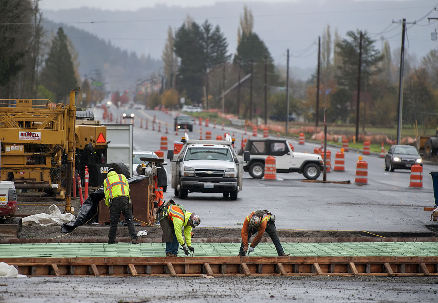 Motorists navigate around construction crews Monday as they continue work to widen state Highway 502 between Interstate 5 and Battle Ground.