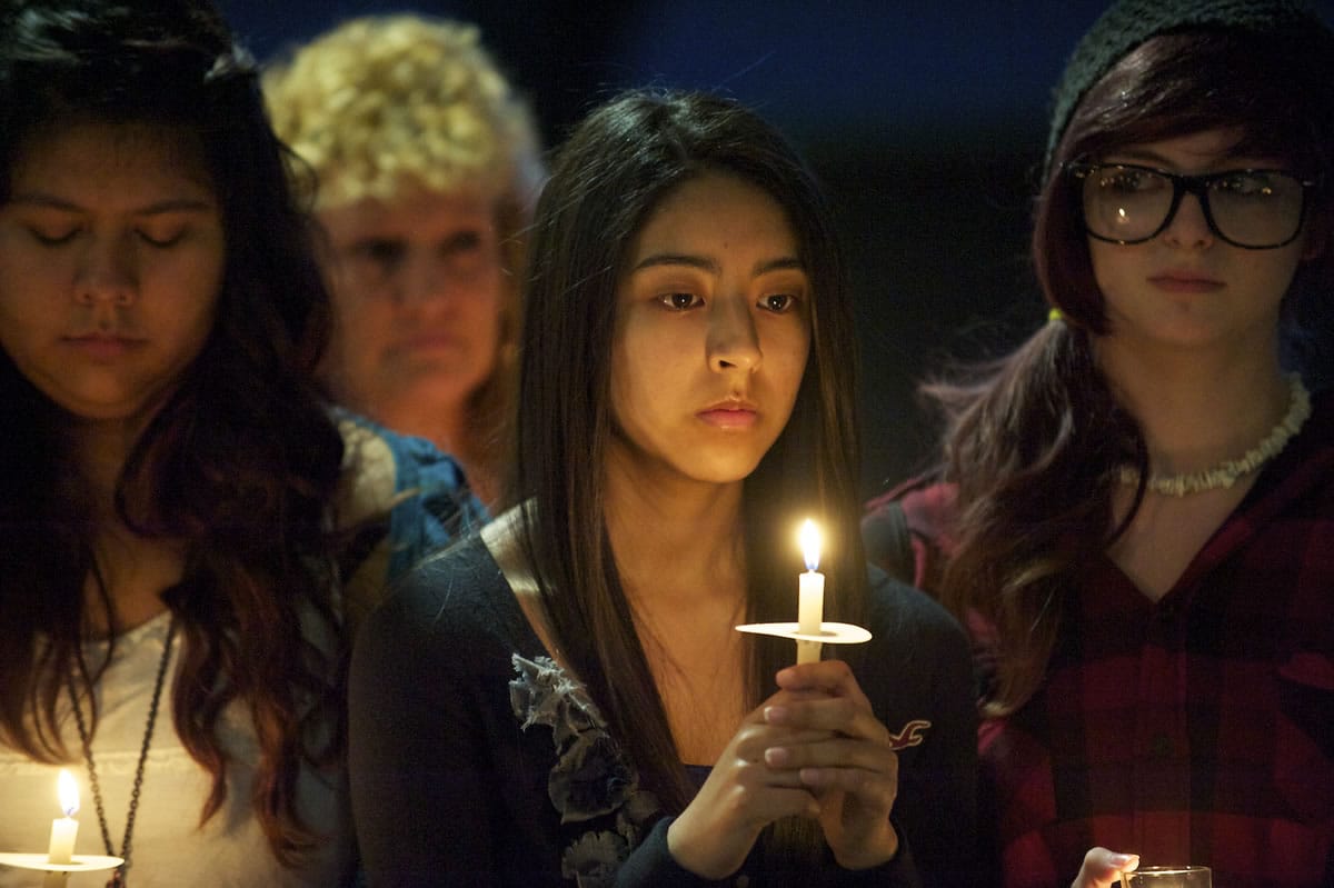Yadira Rodriguez, center, 18, gathers with other friends and classmates of Sergey Bondarchuk in front of Fort Vancovuer High School on Friday evening to remember the senior, who was killed in a car crash last week.