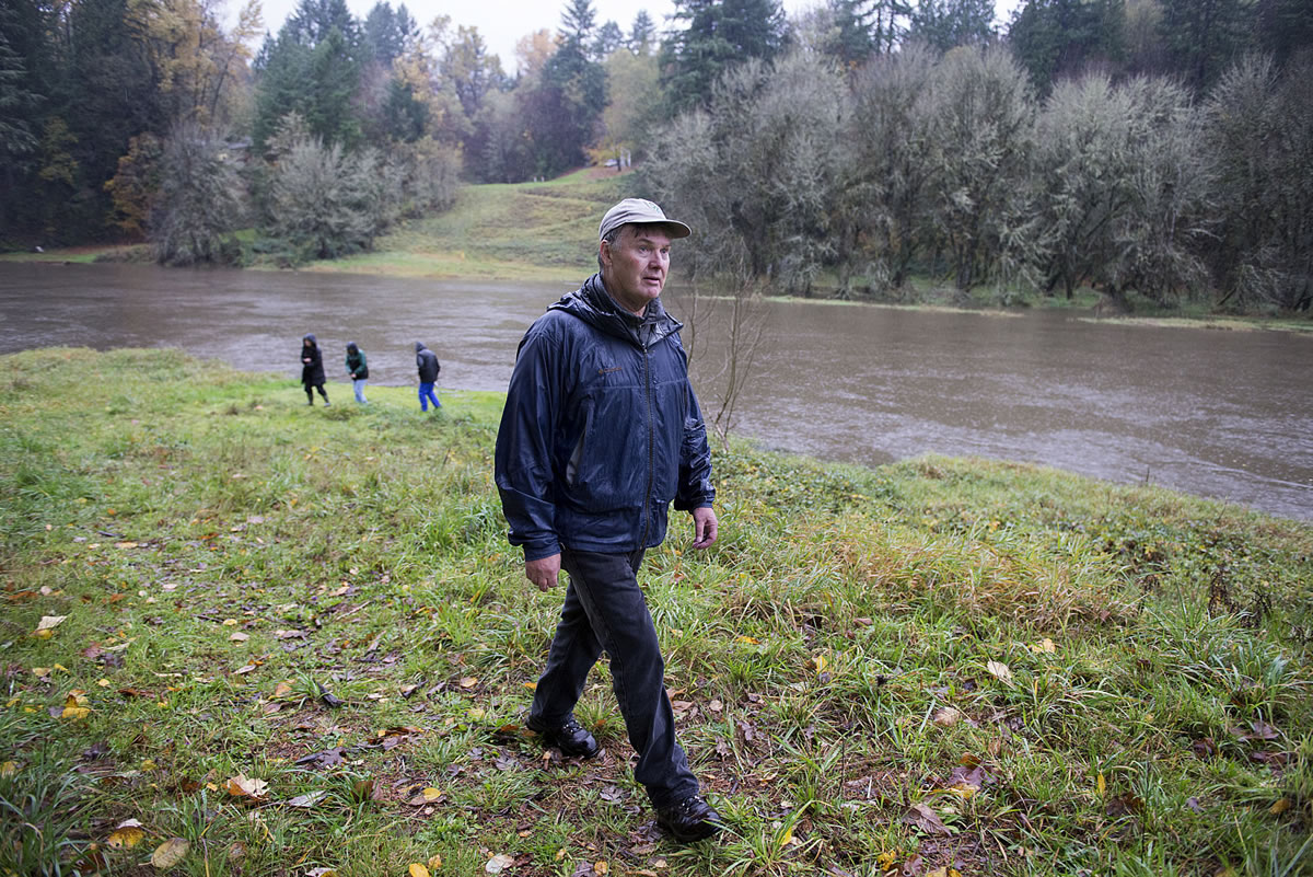 Bill Dygert, an independent land consultant who helped develop Clark County&#039;s Legacy Lands program, strolls on public land near the East Fork of the Lewis River on Tuesday afternoon. Dygert and members of the conservation group Friends of Clark County are protesting the sale of 20 acres immediately south of this property, which they say could provide parking or other amenities for a future waterfront trail.