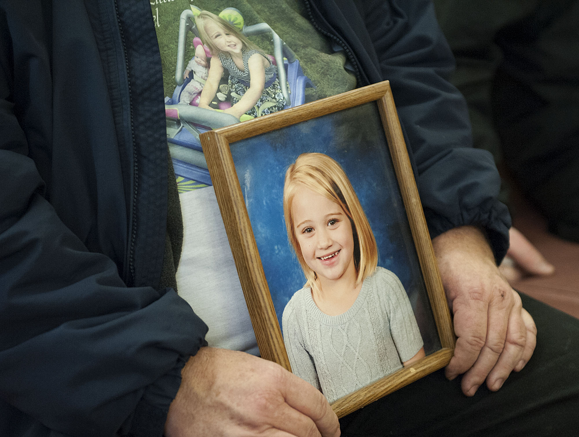 Friends and relatives of Cadence Boyer held photos of her during the sentencing of Duane C. Abbott in November 2015 at the Clark County Courthouse.