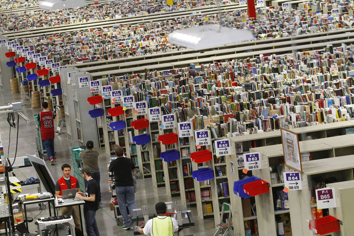 Workers push carts of merchandise at the Amazon.com Phoenix Fulfillment Center in 2010.