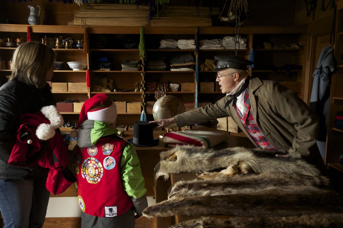 Volunteer John Barnhill educates visitors on pelts at the Indian Trade Shop and Dispensary at Fort Vancouver during the annual Christmas at the Fort event.