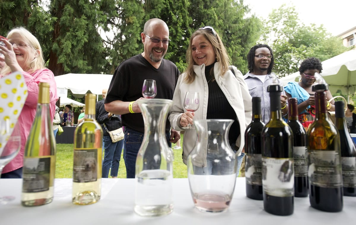 Joe and Michele Stilger of Vancouver sample wines from Moulton Falls winery at last year's Craft Winefest of Vancouver in Esther Short Park.