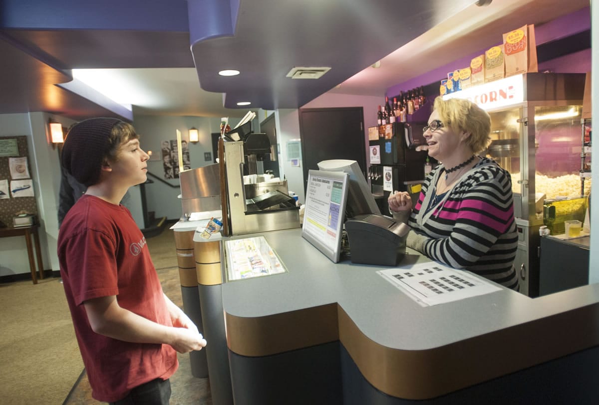 Liberty Theatre employee Angel Brueker sells a movie ticket to Tyler Drake, 15, on a recent Saturday. The Liberty is working to market its offerings to younger moviegoers as part of its effort to attract new audiences.