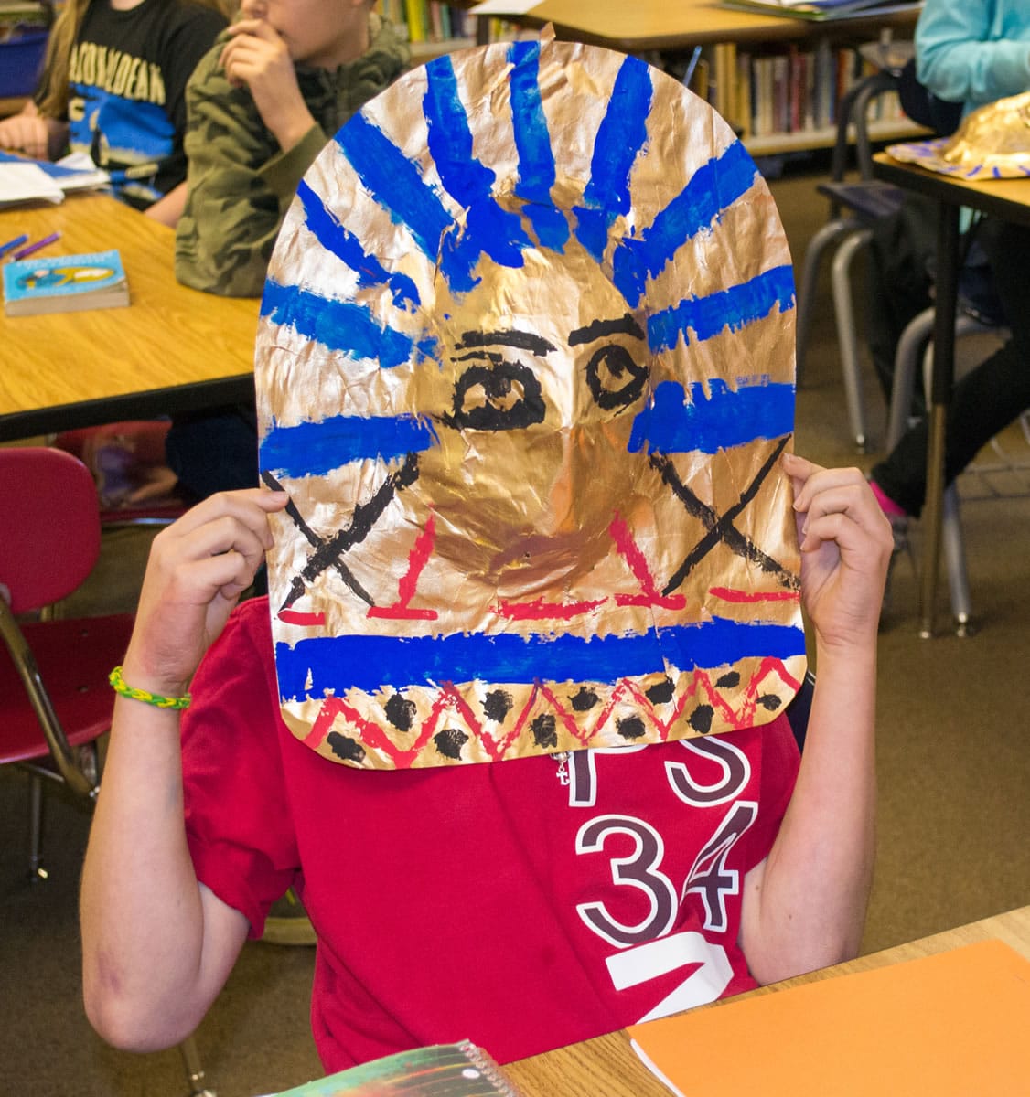 Ridgefield: Union Ridge Elementary School sixth-grader Jason Gasca puts on a mask he made during a recent class lesson on Egyptian history.