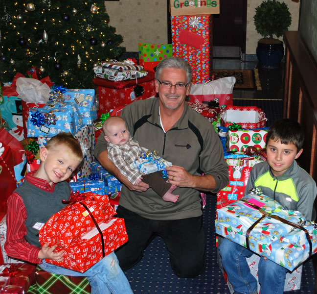 Bennington: Riverview Community Bank Executive Vice President Kim Capeloto and a few employees' children, Landen Whaley, from left, Zane Whaley and Austyn Konopasek, hold gifts in December that were gathered during the bank's annual donation drive for foster children.