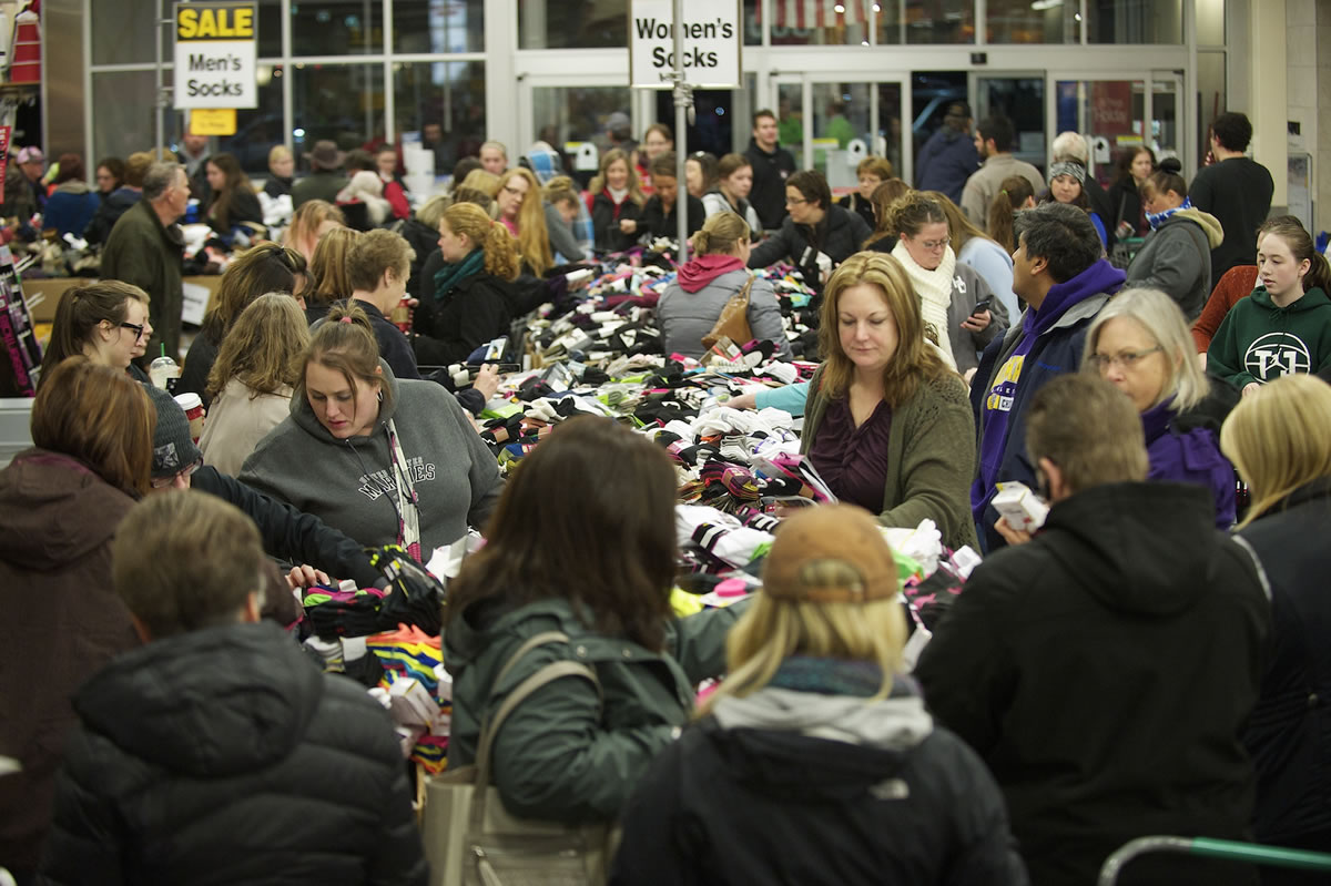 Shoppers at Salmon Creek's Fred Meyer store dig through piles of half-priced socks just after 5 a.m. on Friday, eager to take advantage of the store's Black Friday sale prices.