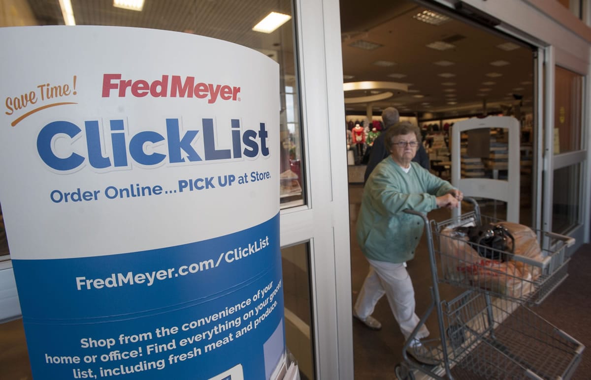 Signs welcome shoppers to participate in online grocery shopping at the Fred Meyer store in Orchards.
