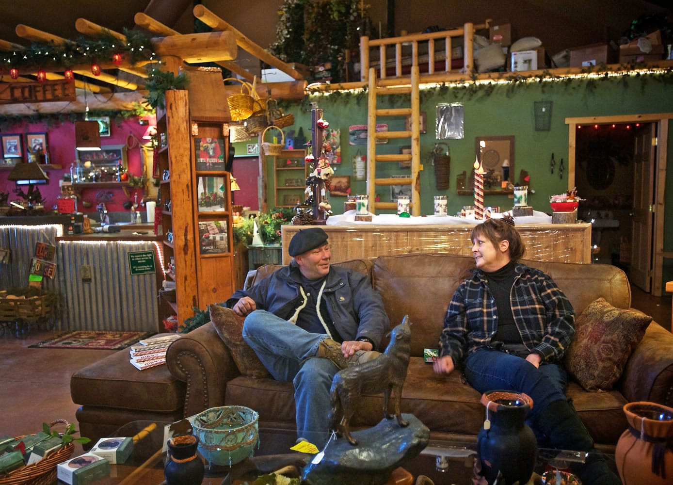 Buddy Carr Jr. and Donna Bergeron talk Dec. 11 at her log furniture shop in Kalama. Bergeron decided to help out the homeless man with food and nights at a Woodland motel after she learned he'd been sleeping under a nearby bridge. Her brother, who she hasn't heard from in 10 years, is also homeless and the issue touches her deeply.