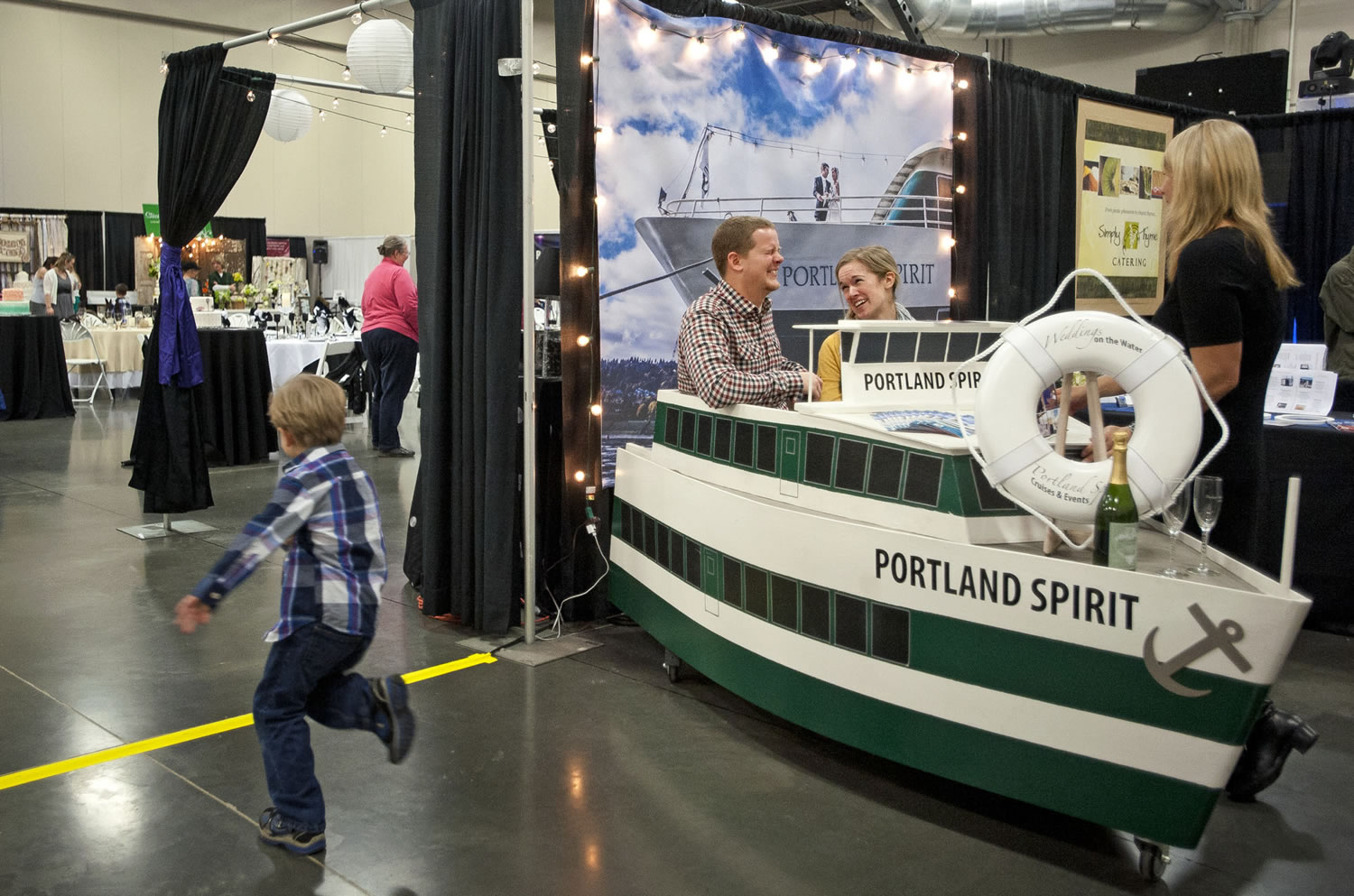 Brittany Weber, 23, and her boyfriend Scott Cook, 25, both of Vancouver, sit on Sunday in a mock-up of the Portland Spirit, a boat used as a wedding venue.