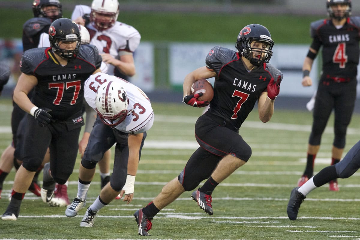Camas running back Nate Beasley carries the ball against Cascade at Doc Harris Stadium, Saturday, November 16, 2013. Beasley scored five touchdowns in a 63-28 win over Cascade.