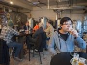 Kevin Fujii of Davis, Calif., enjoys beer with the Friday evening crowd at Mt. Tabor Brewing&#039;s taproom at 113 W. Ninth St. in Vancouver.  With Mt. Tabor&#039;s construction of a new restaurant in Felida and a production facility in Portland, the downtown taproom and brewery will close in June.