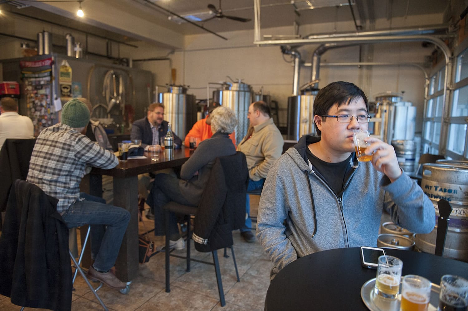 Kevin Fujii of Davis, Calif., enjoys beer with the Friday evening crowd at Mt. Tabor Brewing&#039;s taproom at 113 W. Ninth St. in Vancouver.  With Mt. Tabor&#039;s construction of a new restaurant in Felida and a production facility in Portland, the downtown taproom and brewery will close in June.