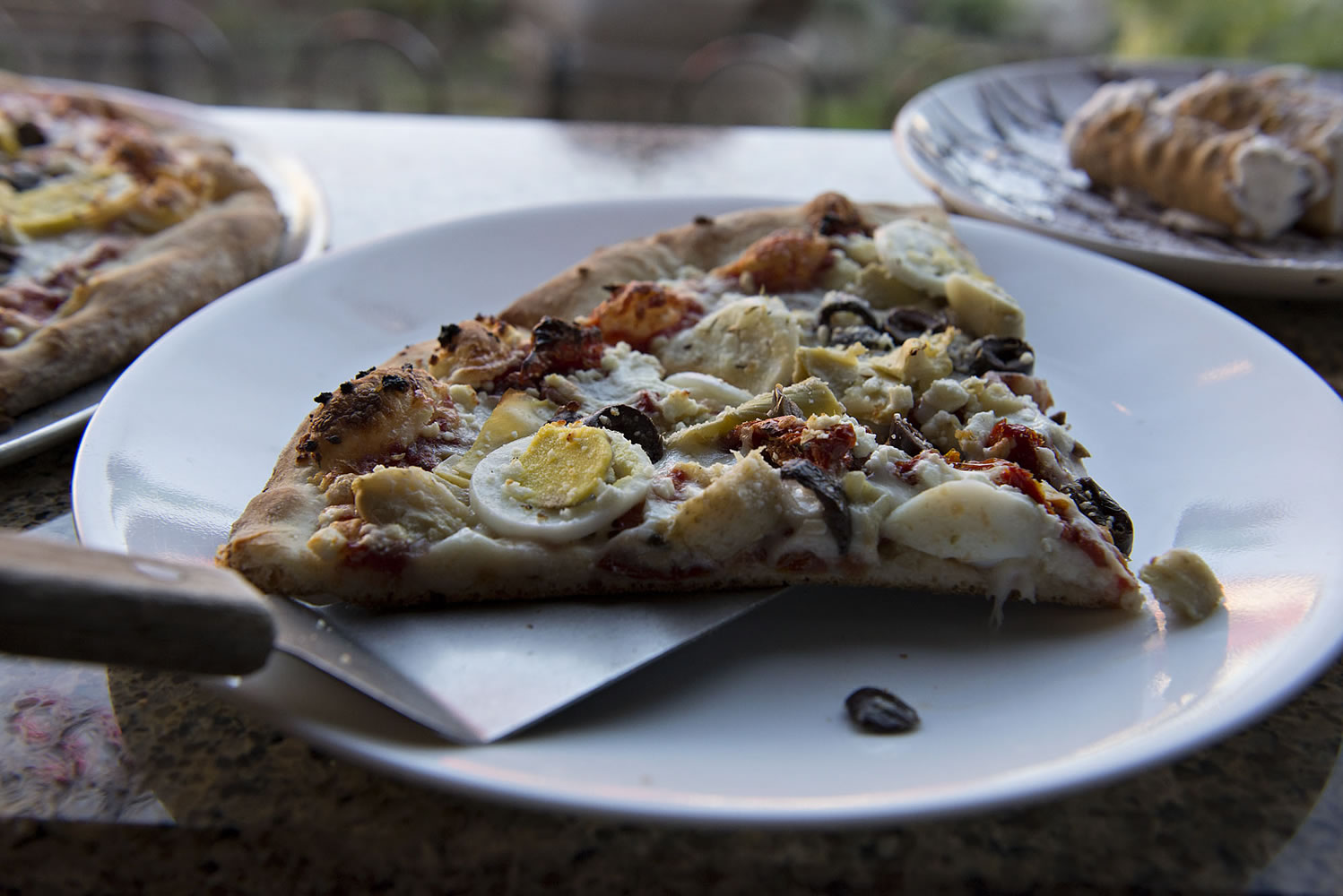 Two slices of Mediterranean pizza are served Nov. 3 next to a plate of cannoli at Vinnie&#039;s Pizza in downtown Vancouver.