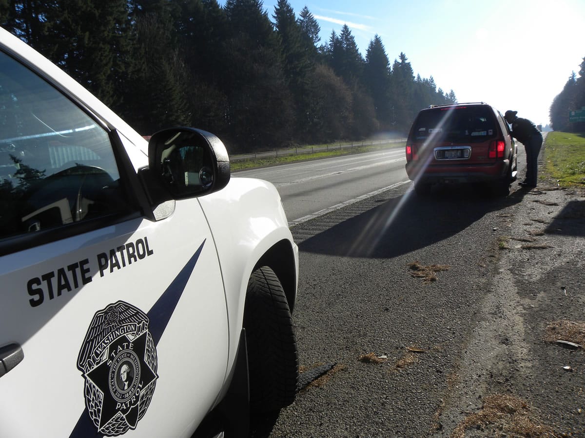 Eric Florip/The Columbian
Washington State Patrol Chief John Batiste speaks to a driver during a traffic stop on Interstate 5 near Ridgefield on Monday. State police in Washington, Oregon and California are stepping up enforcement and education efforts this week with the goal of no fatal crashes on I-5 during the Thanksgiving weekend.
