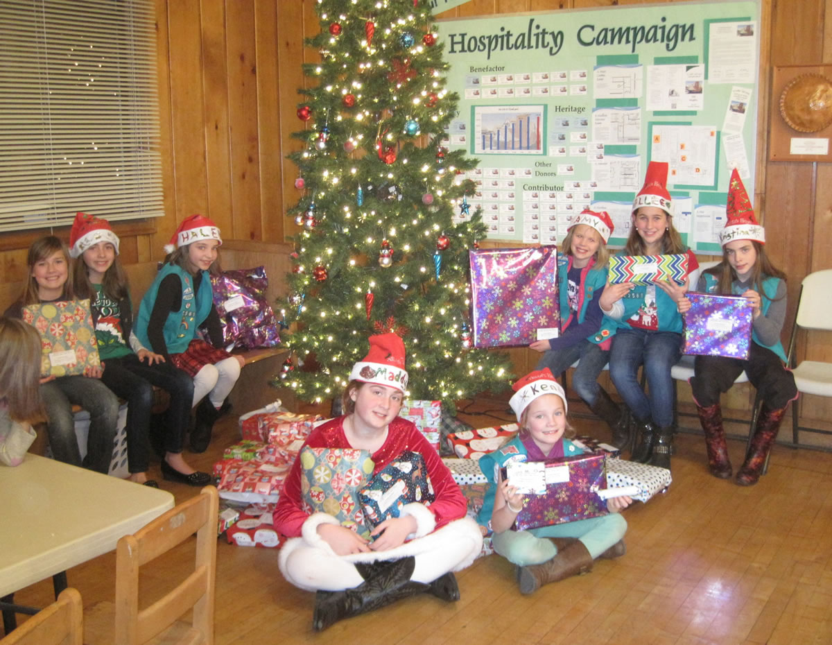 Shumway: Members of Girl Scout Troop 42561 hold gifts they helped gather that will be donated to Share House for Christmas.