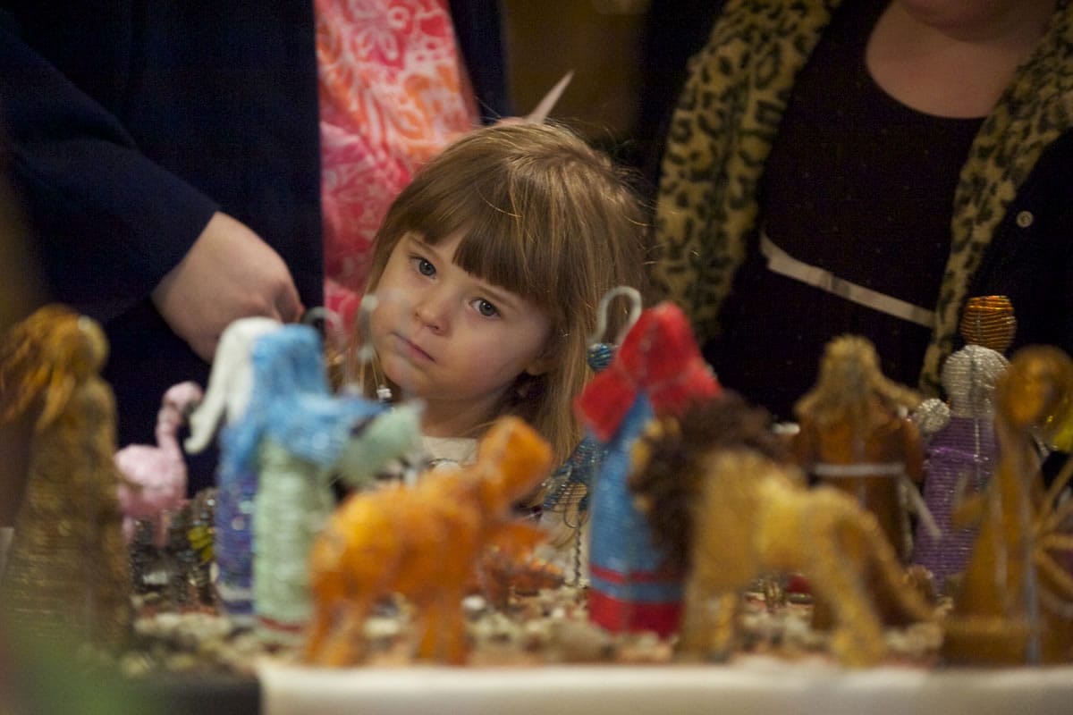 Lily Bowler, 4, of Vancouver looks at nativities from around the world Sundayat the Festival of Nativities.