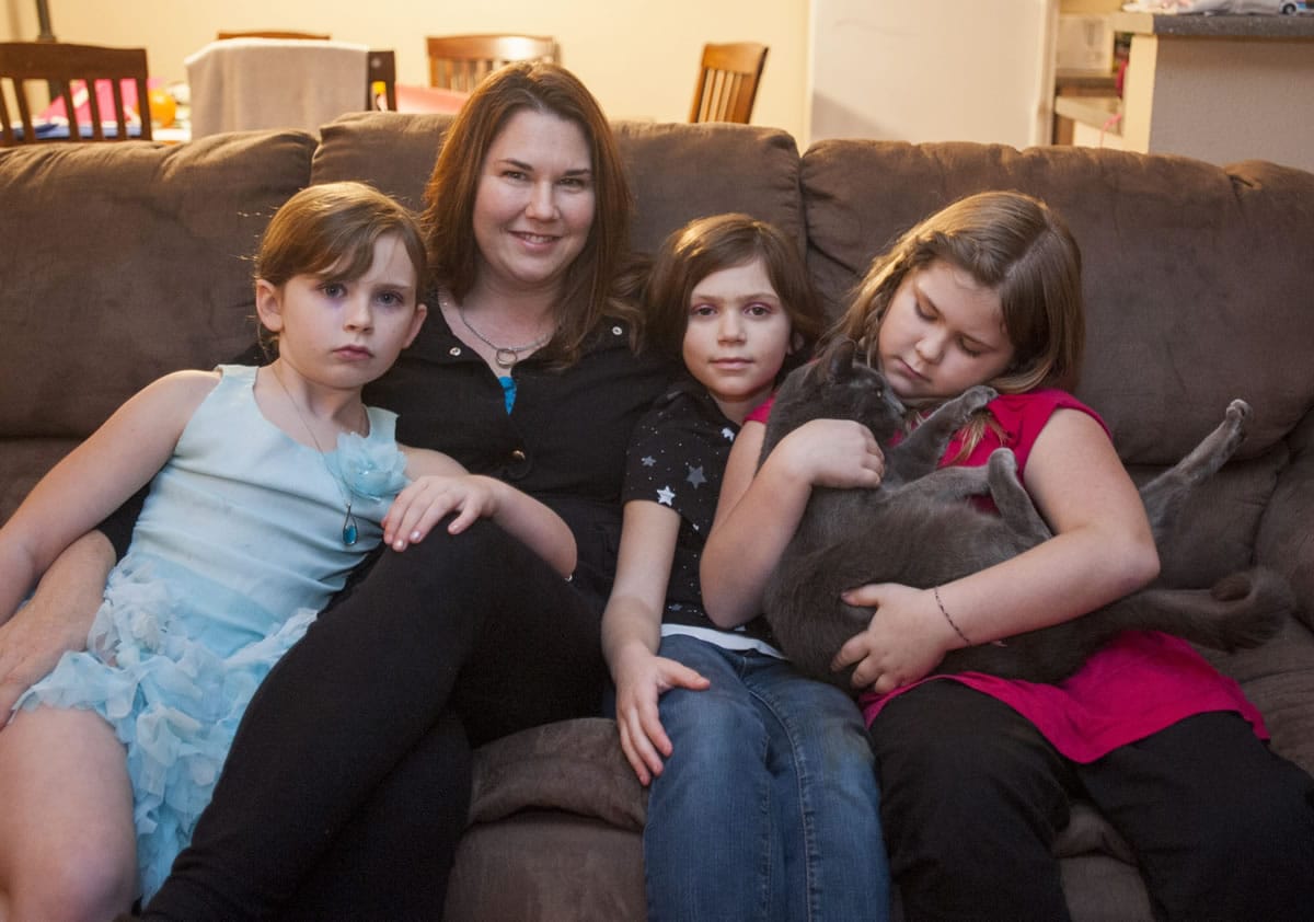 Angie Ballantyne gathers with her daughters -- from left, Alayna, 6; Ilisha, 7; and Melia, 9 -- at their home in Vancouver. Ballantyne&#039;s husband is serving a 25-year sentence in prison, and she and her family benefit from Families on the Outside, a nonprofit aimed at supporting families of prisoners.