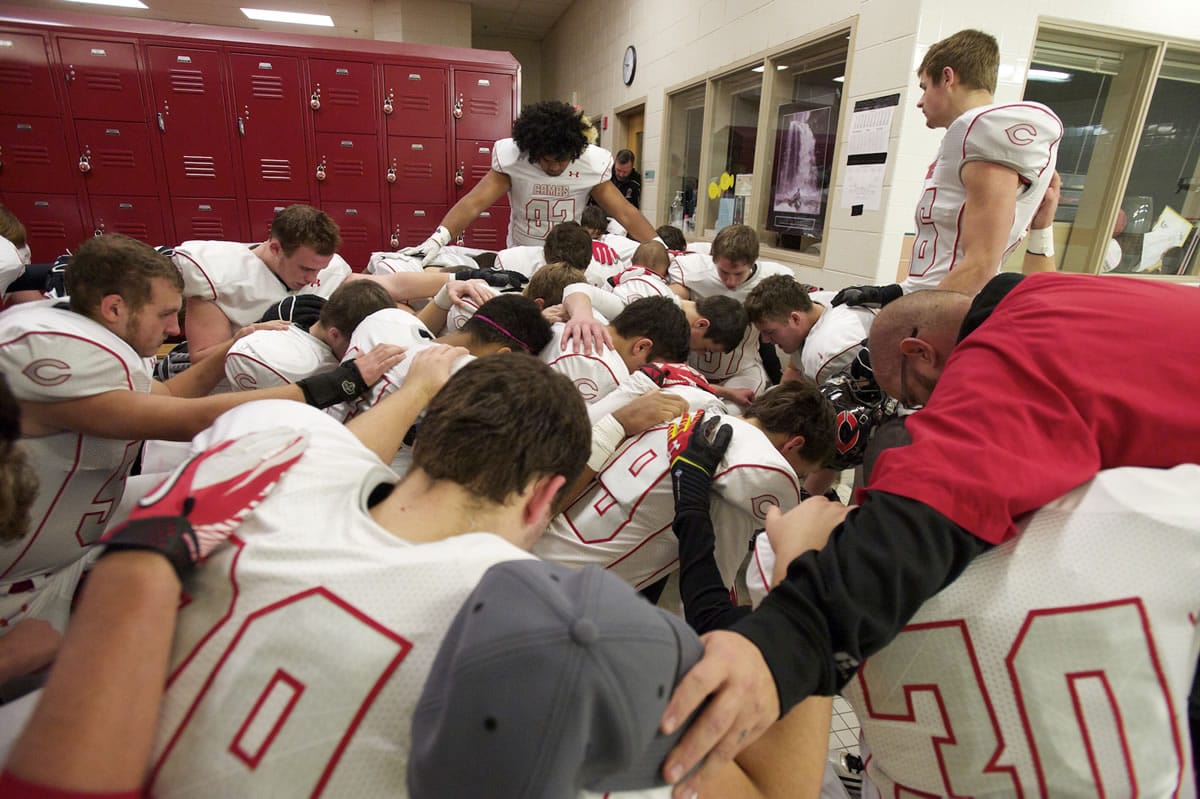 The Camas football team prays before its Class 4A quarterfinal game against Eastlake at Eastlake High School in Sammamish on Nov. 23.