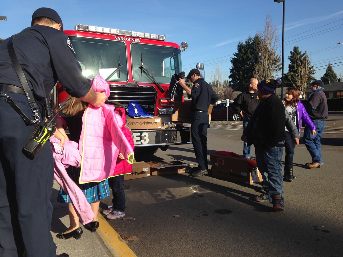 Fruit Valley: Members of the Vancouver Firefighters' Union IAFF Local 452 deliver new coats to children on Nov. 25 at the Fruit Valley Community Learning Center.