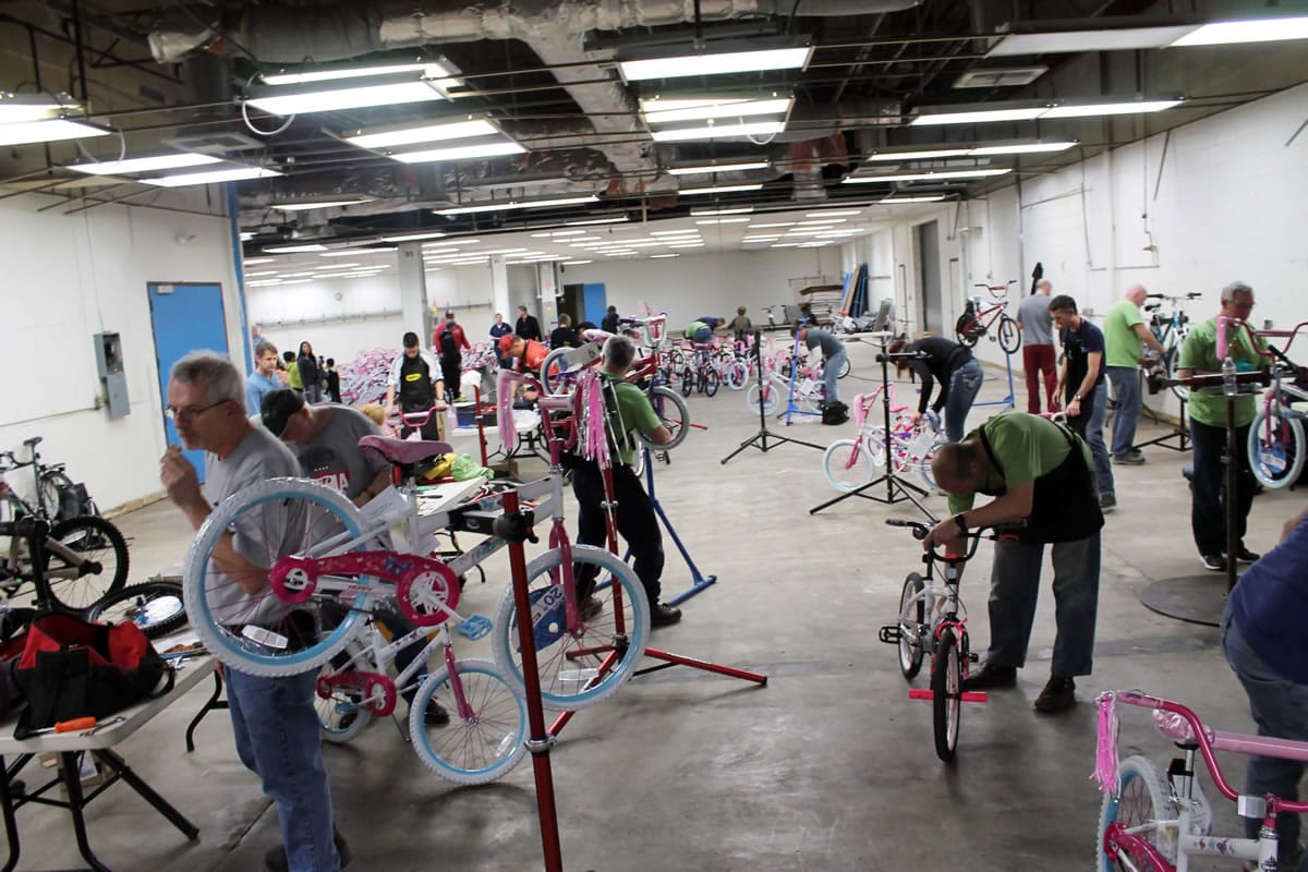 Columbia Way: Volunteers build hundreds of bikes on Dec. 5, part of Waste Connections' annual &quot;Christmas Promise&quot; program.