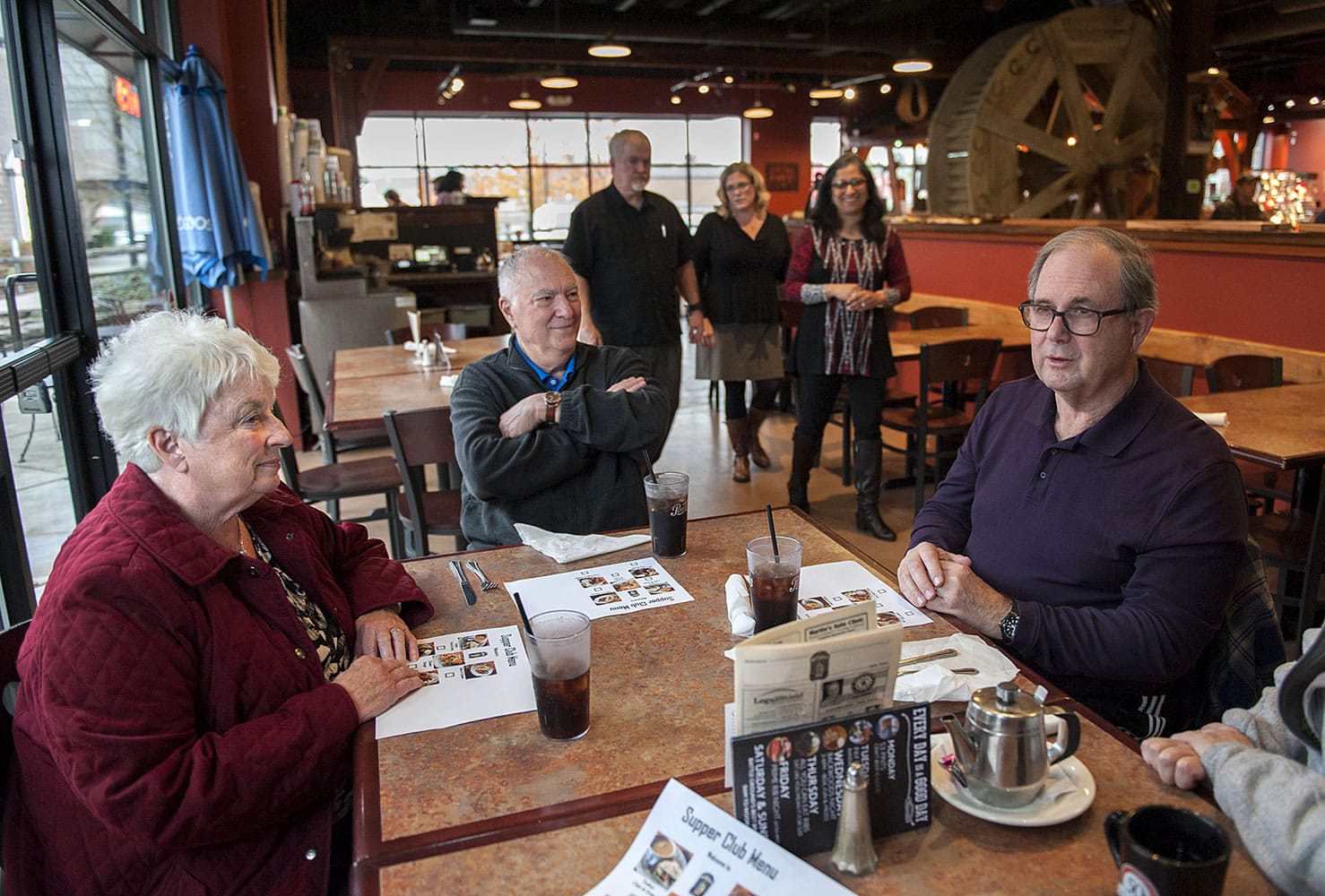 Mary Senescu, left, has a meal out with her husband, Larry, and new friends Gerry and Moira Quilling at the Mill Creek Pub. Gerry remains a great talker except when he has to fish for words; Larry is almost completely nonverbal but keeps flashing that wise smile. Behind the diners are Mill Creek Pub owner Russell Brent, Julie Williams of Home Instead Senior Care and Shanti Potts, a volunteer with the Elder Justice Center.