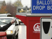 Voters use a drive-up collection box to cast their ballots Monday near the Clark County Elections Office, 1408 Franklin St., in downtown Vancouver. They have until 8 p.m. today to drop their ballots in one of the drop boxes located throughout the county.