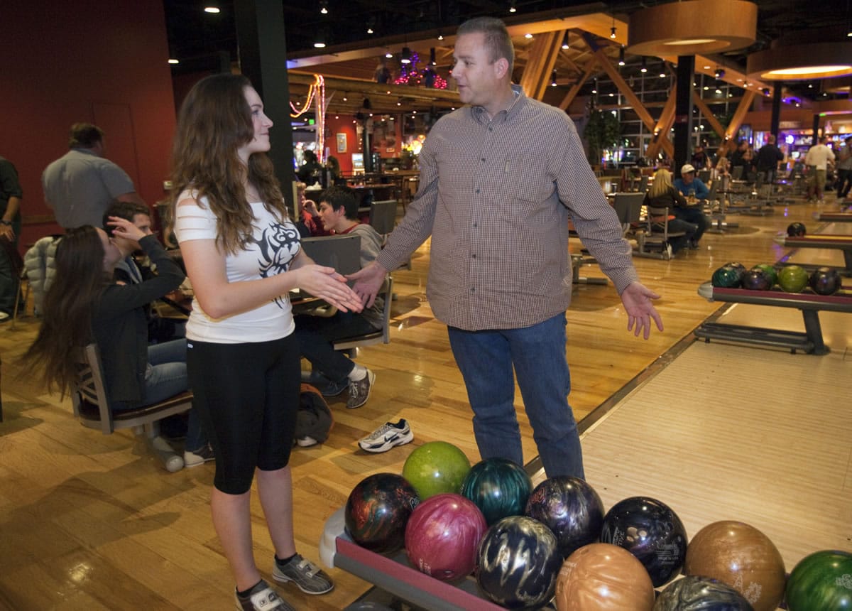 Clark County sheriff's Sgt. Shane Gardner talks with student Anji Dean, 16, while out bowling with the Explorer program earlier this year.
