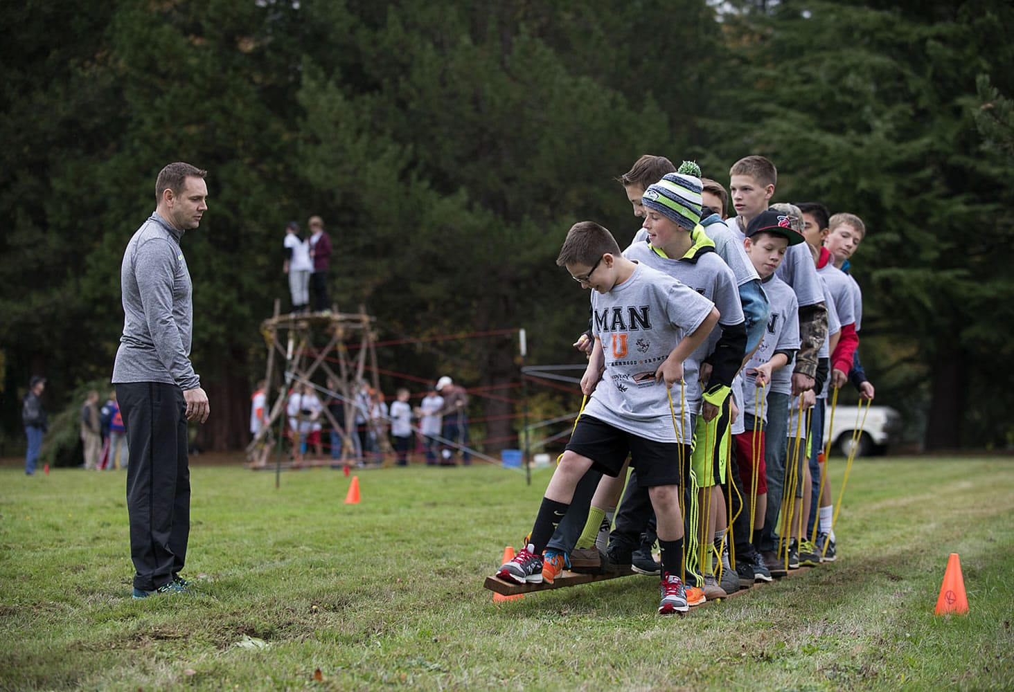Blake Perkins of Washougal offers encouragement to participants as they take part in a team-building activity for eighth-grade boys Thursday afternoon at Jemtegaard Middle School.