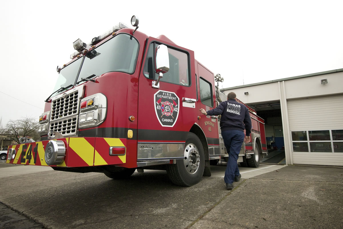 Camas firefighter Brad Delano pulls a fire engine out for routine inspection at Camas Station 41.