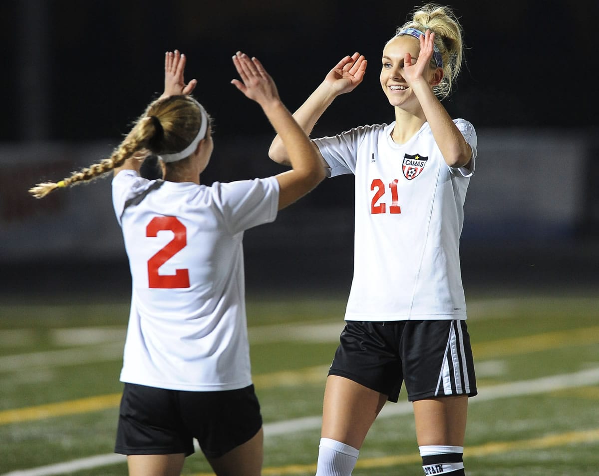 Perri Belzer (2), here greeting teammate Mason Minder (21), set up one of the two goals in the Papermakers&#039; 2-0 win over Lake Stevens on Tuesday.