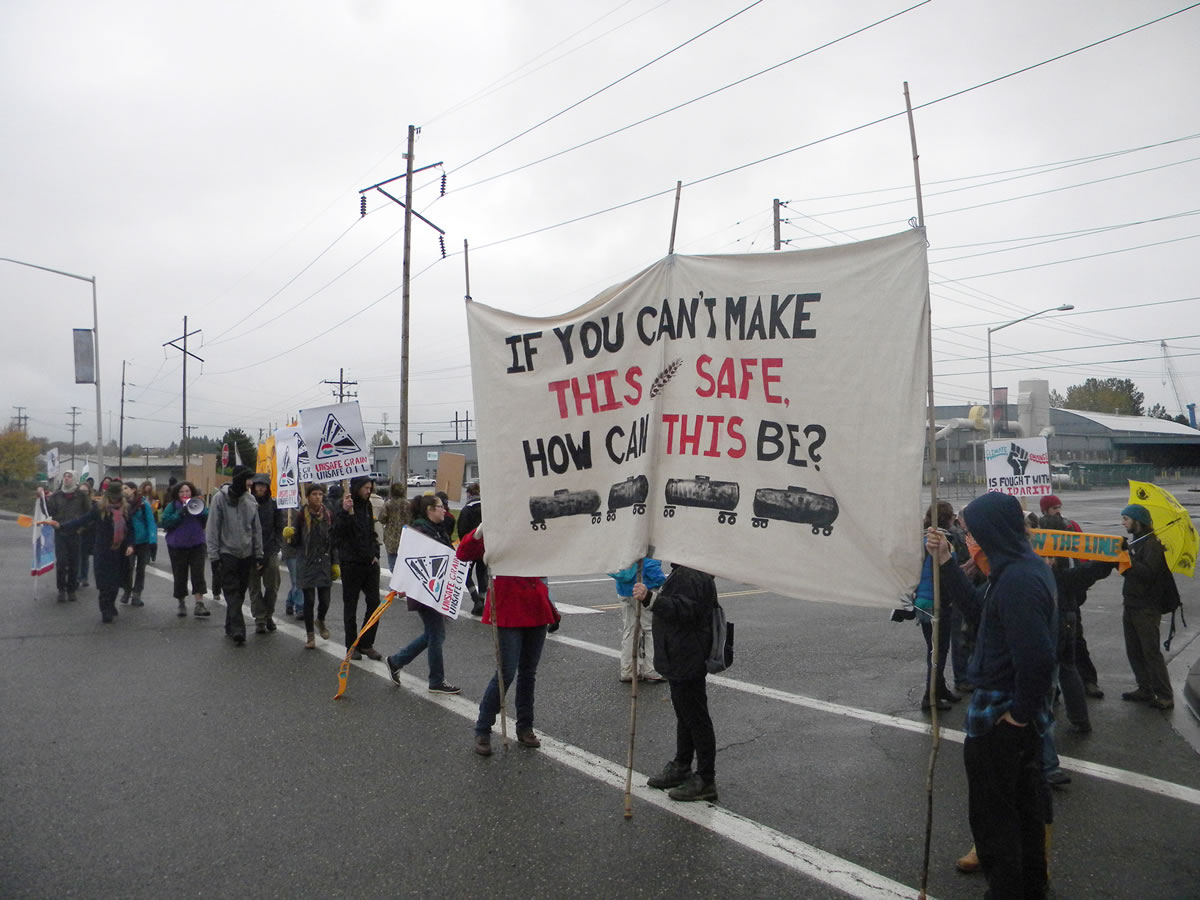 Demonstrators from Rising Tide, an environmental group with chapters in Portland and Vancouver, carried signs and chanted Monday morning in protest of an oil-transfer terminal proposed for the Port of Vancouver. About 50 people joined in the Monday morning event.