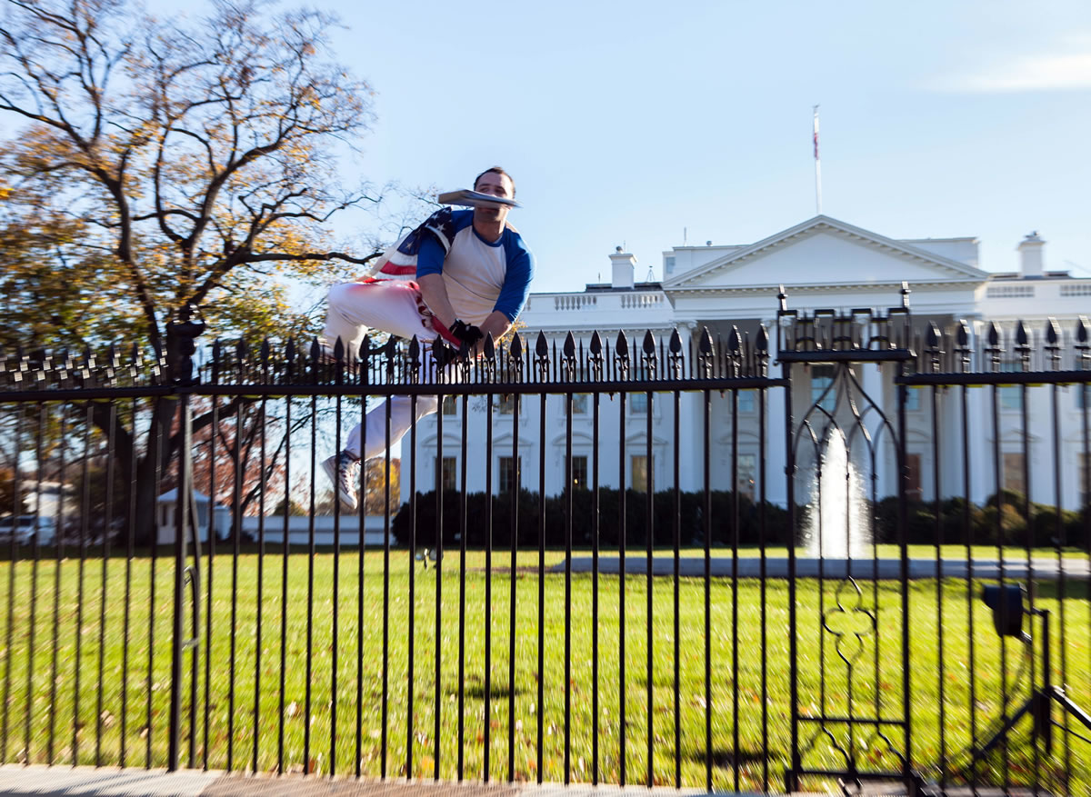 In this photo provided by Vanessa Pena, a man jumps a fence at the White House on Thursday, Nov. 26, 2015, in Washington. The man was immediately apprehended and taken into custody pending criminal charges, the Secret Service said. President Barack Obama and his wife and daughters were spending Thanksgiving the holiday at the White House.