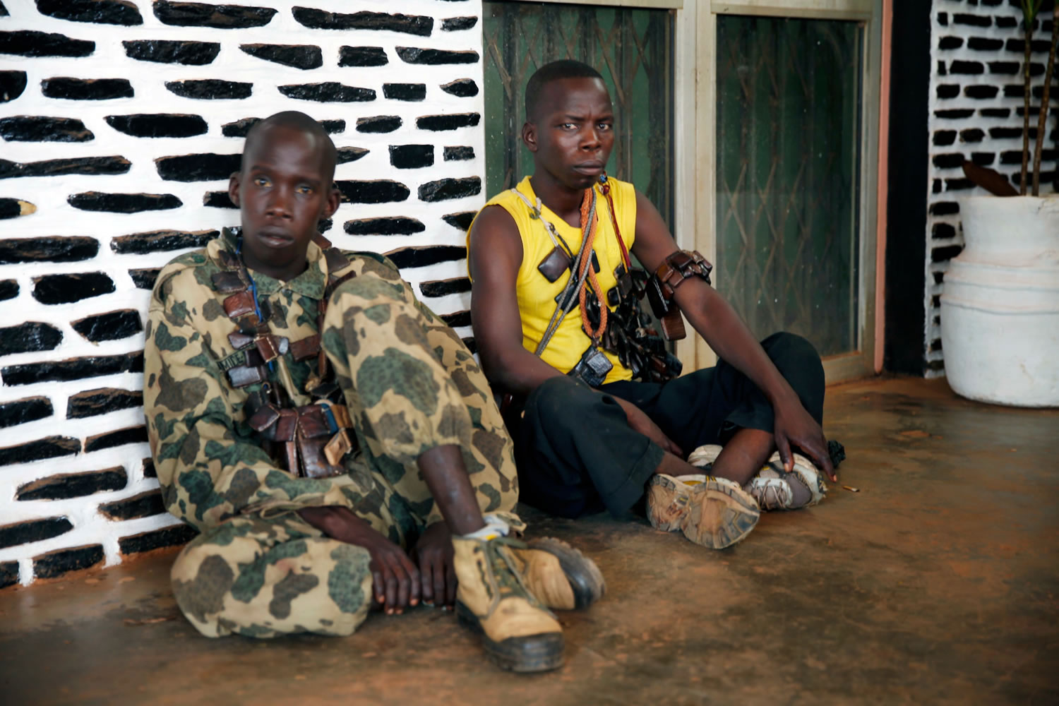 Seleka soldiers wearing lucky charms around their necks wait outside Bangui's hospital, Bangui, Central African Republic, on Thursday following a day-long gun battle between Seleka soldiers and Christian militias.