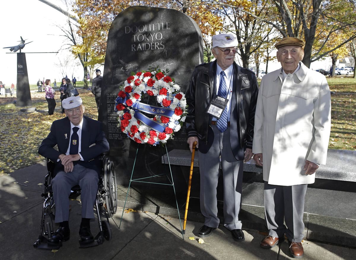 David Thatcher, from left, Edward Saylor, and Richard Cole, three of the four surviving members of the 1942 Tokyo raid led by Lt. Col. Jimmy Doolittle, pose Saturday at a monument marking the raid outside the National Museum for the U.S. Air Force in Dayton, Ohio.