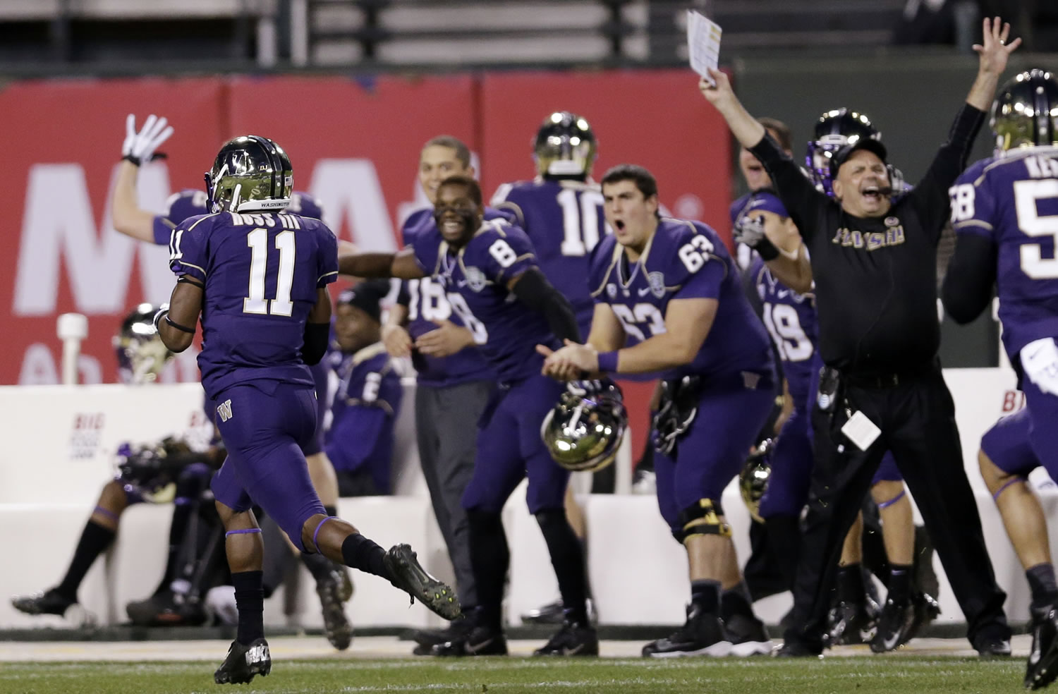 Washington's John Ross, left, returns a kickoff 100 yards for a touchdown against BYU during second quarter of the Fight Hunger Bowl at San Francisco.