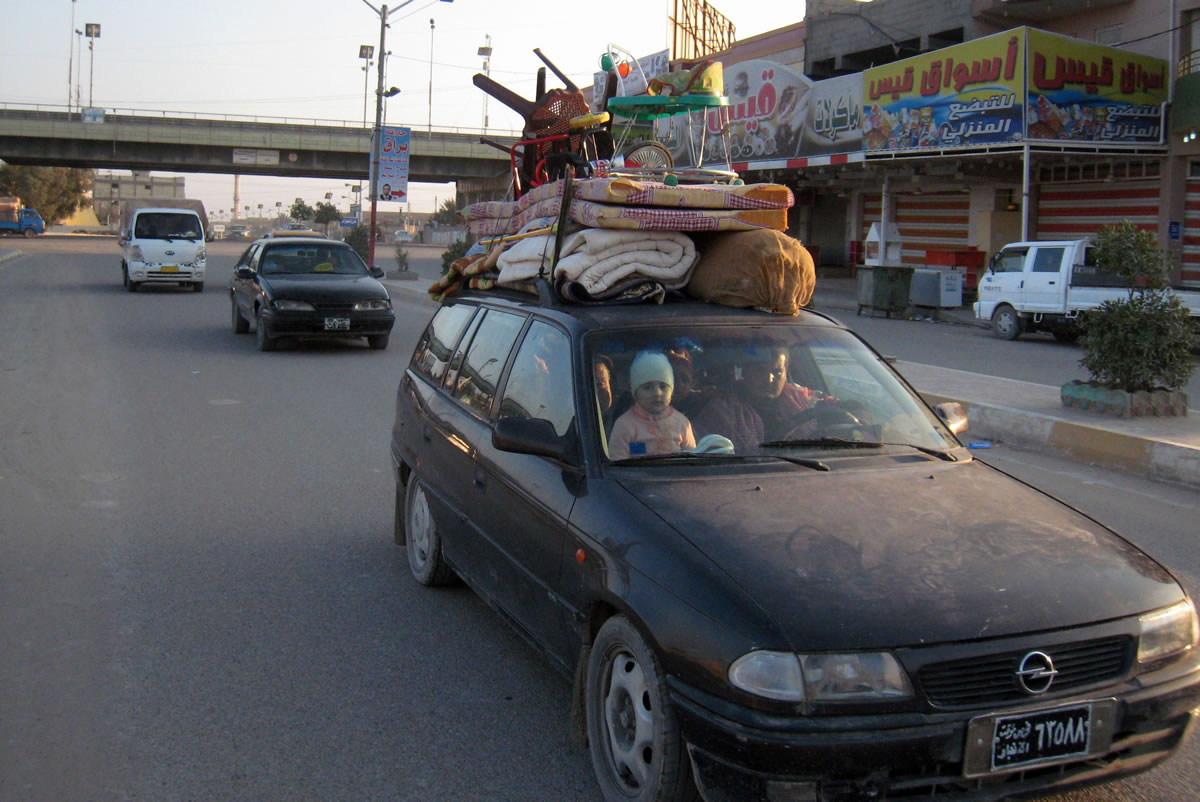 An Iraqi family, with their belongings strapped to their car, flee their home during clashes between the Iraqi army and al-Qaida fighters in Fallujah, Iraq, 40 miles west of Baghdad, on Monday.