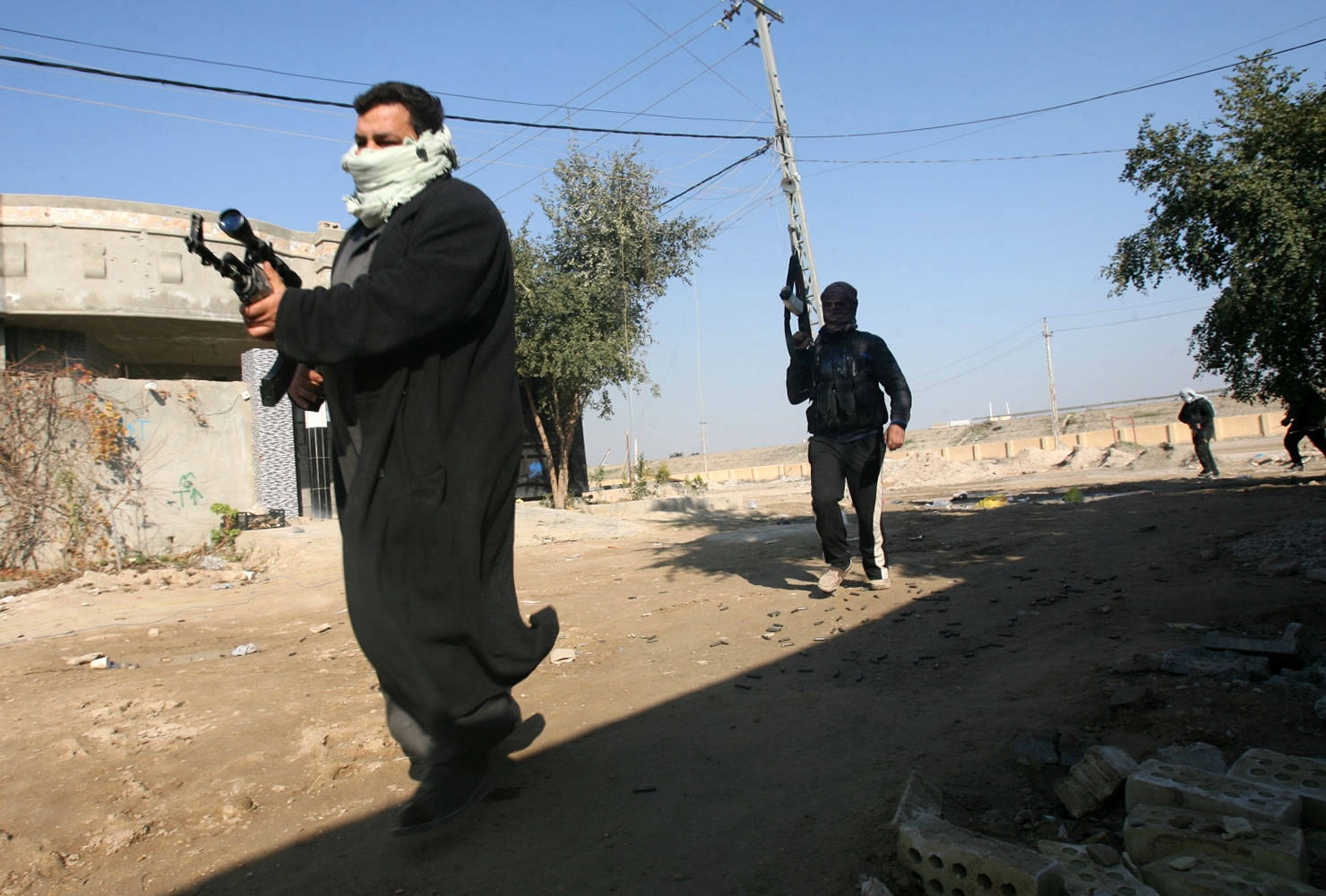 Gunmen patrol during clashes with Iraqi security forces Thursday in Fallujah, 40 miles west of Baghdad, Iraq.