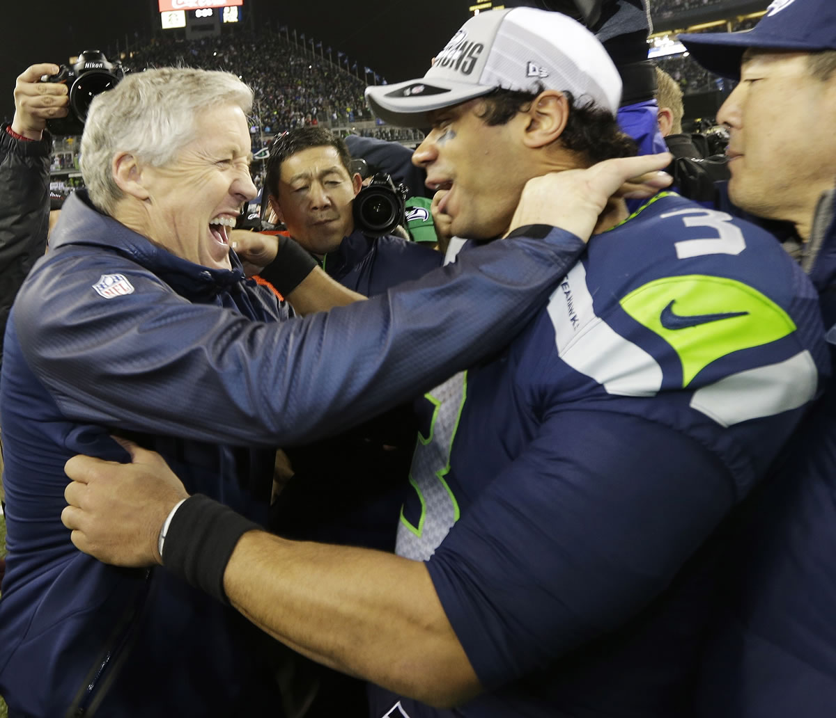 Seattle Seahawks head coach Pete Carroll celebrates with quarterback Russell Wilson after the host Seahawks won the NFC Championship Game 23-17 against the San Francisco 49ers.