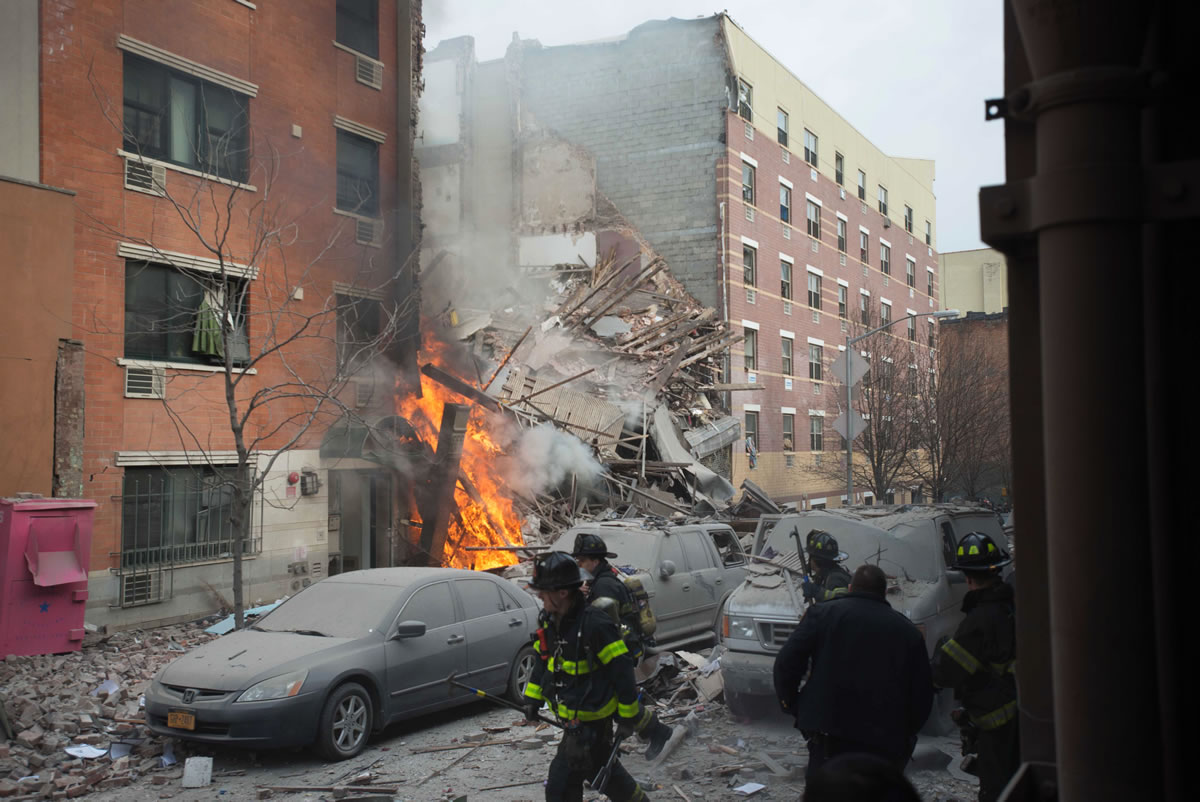 Firefighters work the scene of an explosion that leveled two apartment buildings in the East Harlem neighborhood of New York on Wednesday .