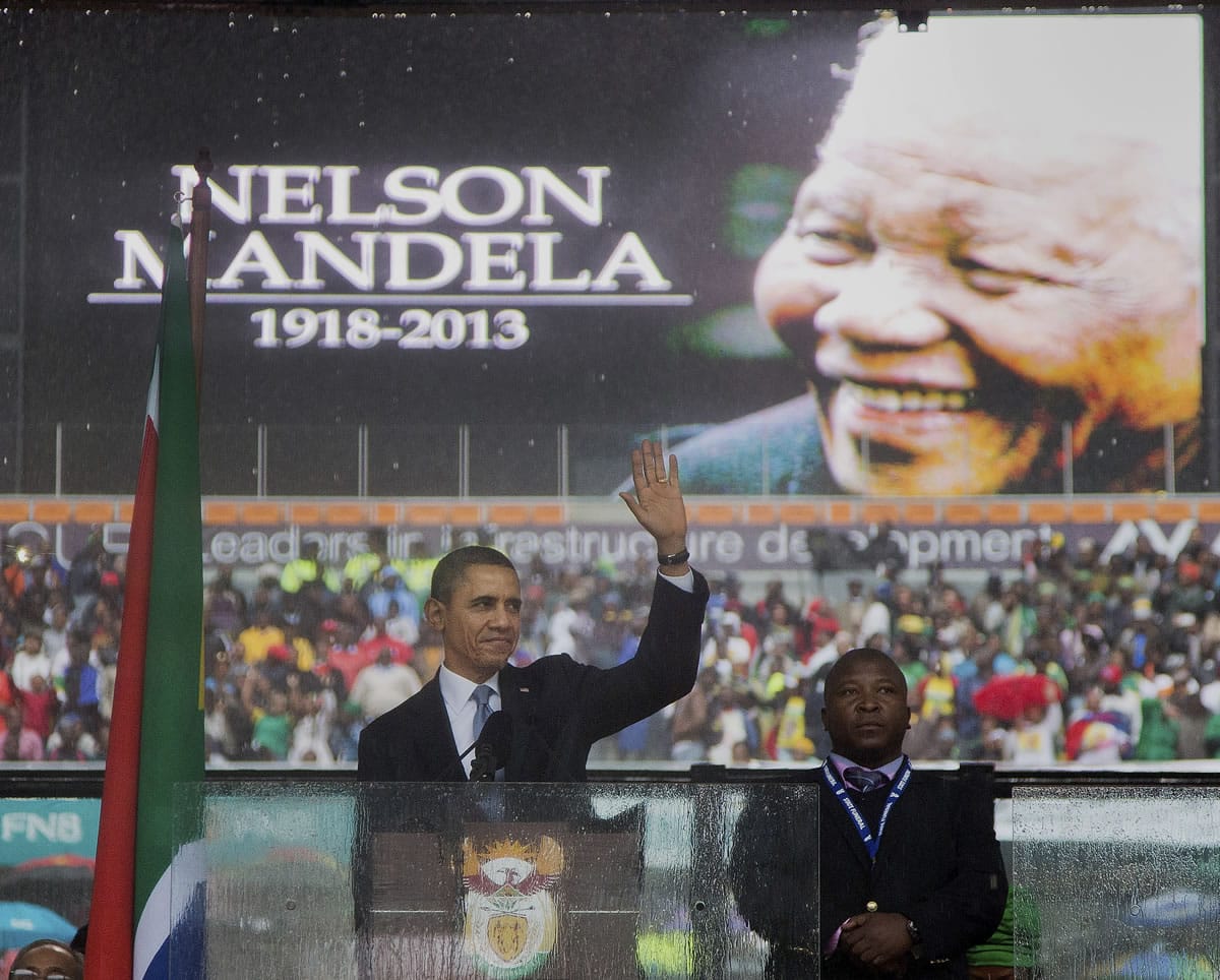President Barack Obama waves as he arrives to speak at the memorial service for former South African president Nelson Mandela at the FNB Stadium in the Johannesburg, South Africa township of Soweto, on Tuesday.