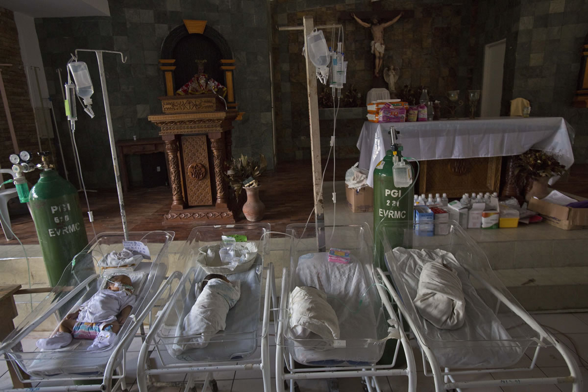 Sick and premature babies lie in cribs on the altar of a Catholic chapel inside the Eastern Visayas Regional Medical Center in Tacloban on Saturday.