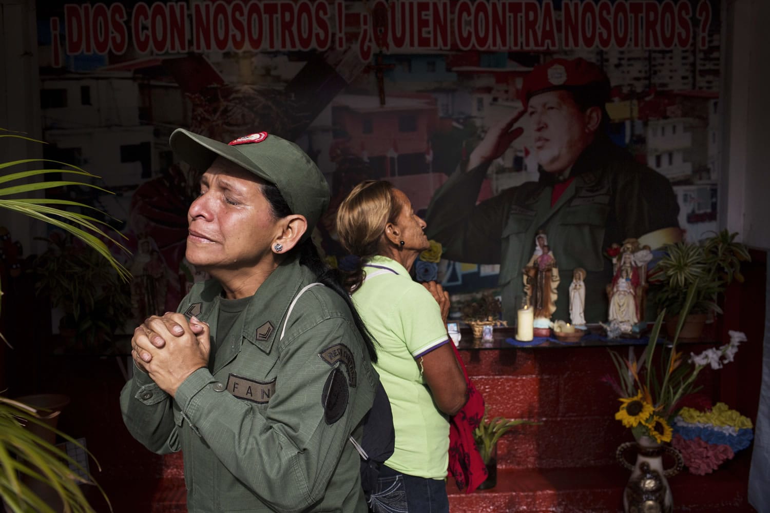Marisol Perez, a Venezuelan Army specialist, cries while visiting a chapel to mark the one-year anniversary of the death of President Hugo Chavez on Wednesday in Caracas, Venezuela.