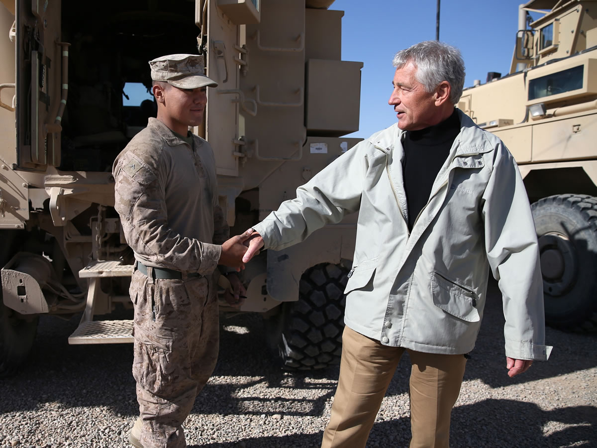 U.S. Secretary of Defense Chuck Hagel, right, shakes hands with U.S. Marine Lance CPL.
