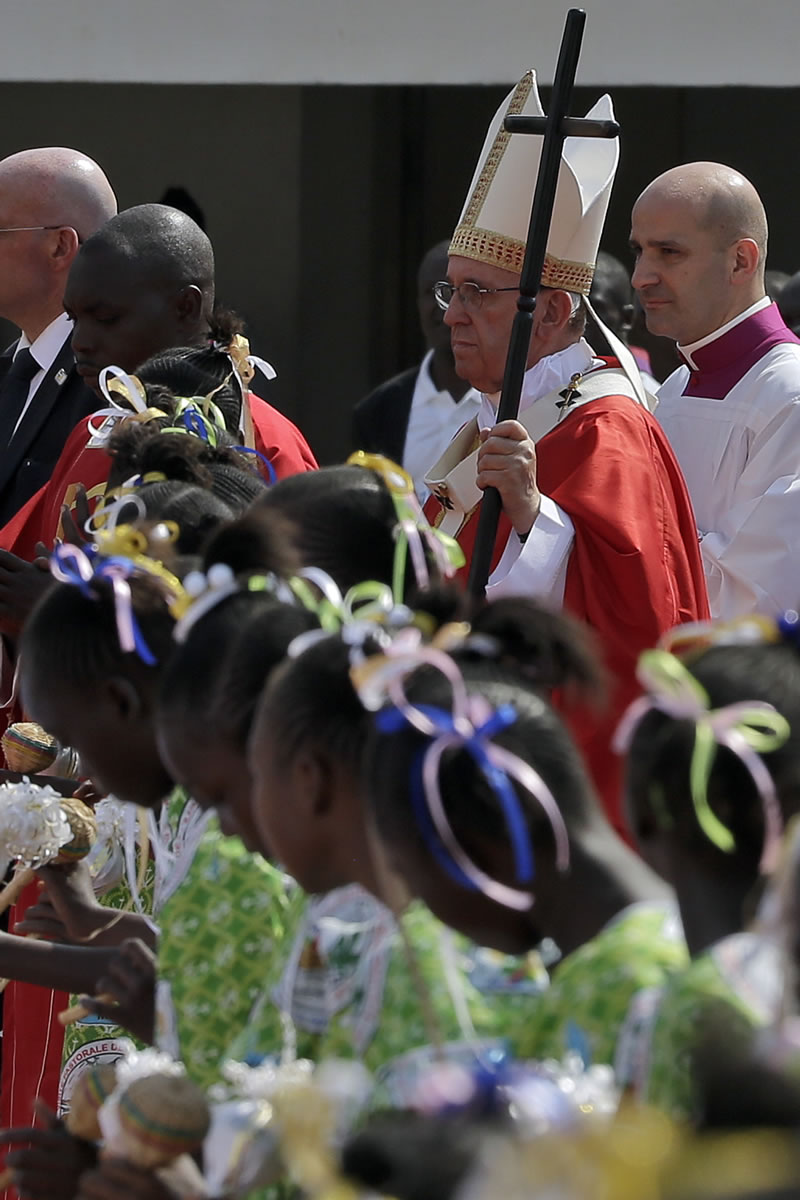 Pope Francis celebrates a mass Monday in the Barthelemy Boganda Stadium in Bangui, Central African Republic. The pontiff returned to Italy on Monday after a visit to Africa.